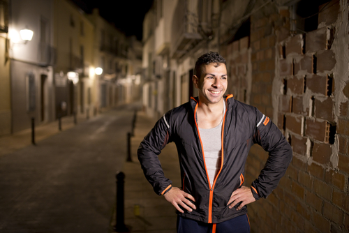 Man taking a break after a run at night