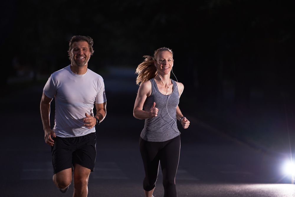 Man and woman fitness walking at night