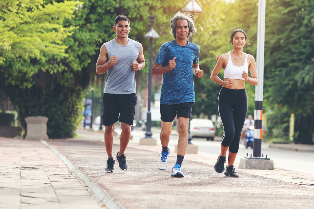 3 joggers jogging on a city street