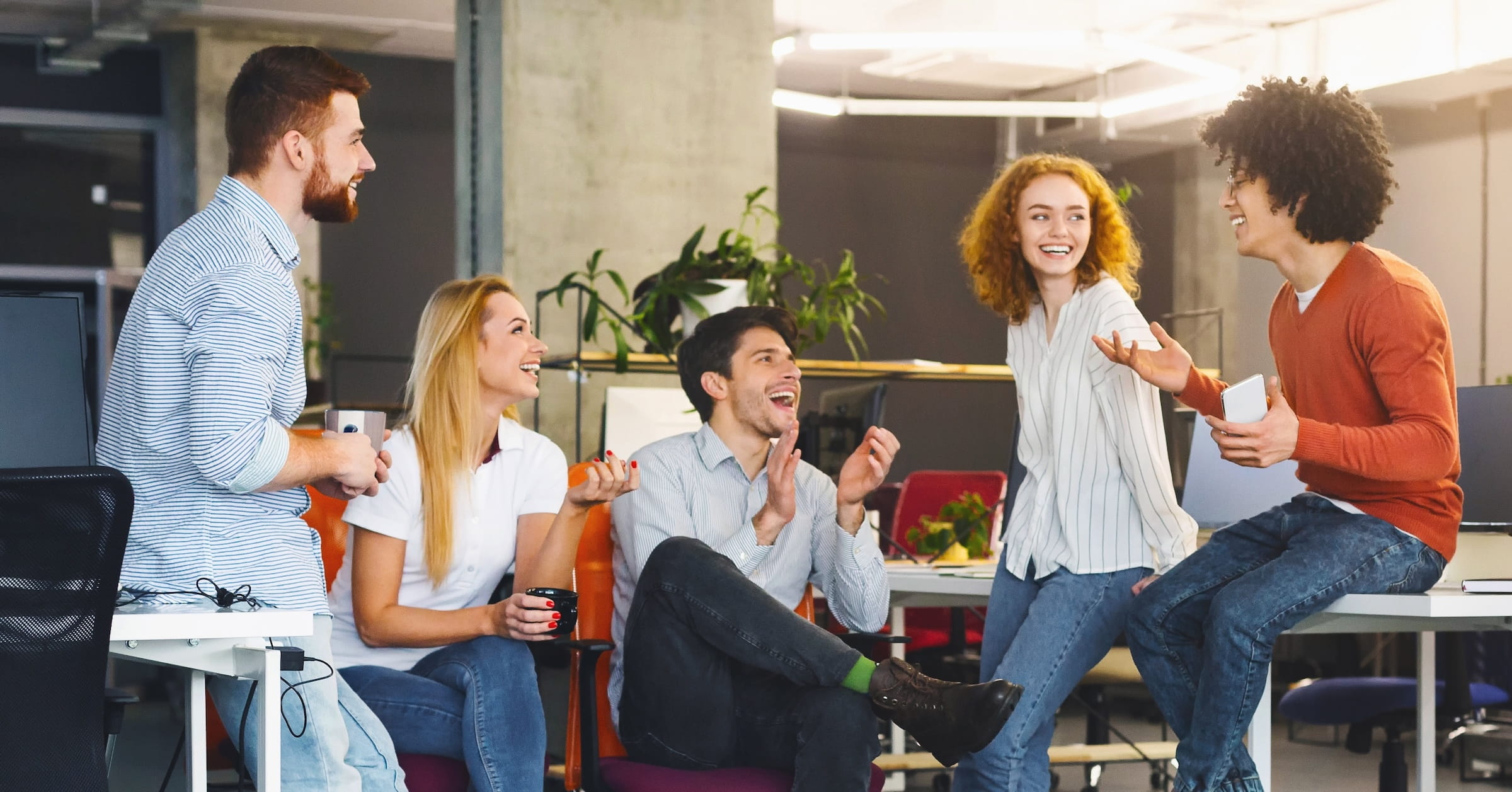 Coworkers walking together in a bright office lobby during an office step challenge