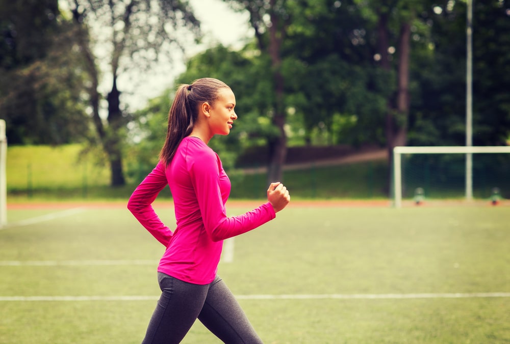 Woman speed walking on a track for fitness