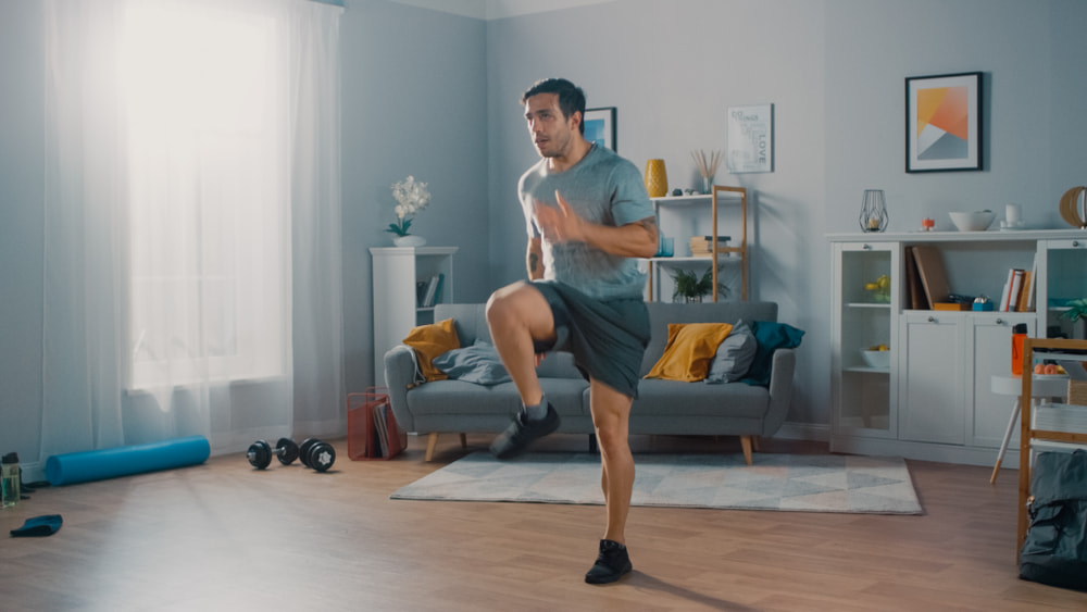 Man running in place at home for fitness