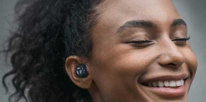 Close up of woman wearing Tranya earbuds