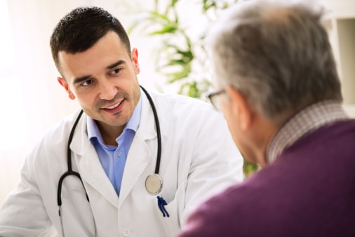 Senior man talking to doctor about health