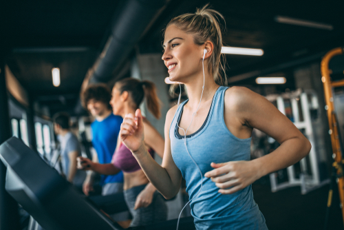 Young sporty people running on a treadmill