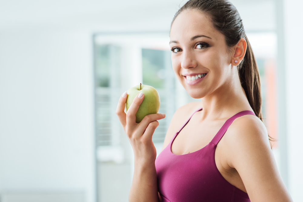 Woman eating an apple healthy lifestyle concept