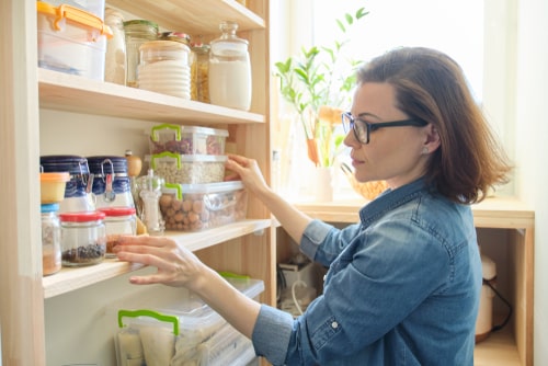 Woman checking her pantry at home