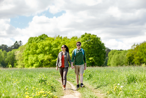 Couple walking in a wooded countryside