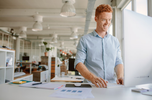 Man standing at a standing desk