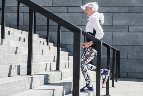 Senior woman walking stairs for fitness