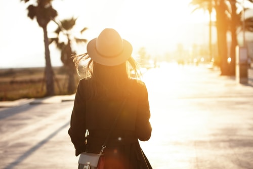 Silhouette of woman walking in morning