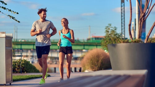 Couple walking for fitness in a city park