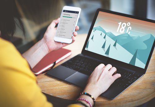 Checking weather forecast on laptop