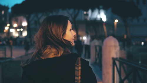 Woman walking in a dark area