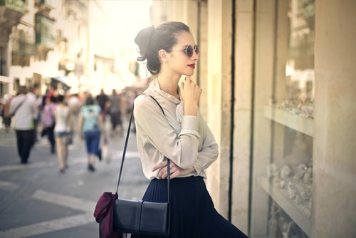 Woman looking in a store window windowshopping
