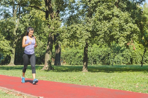 Woman fitness walking on a park walking track