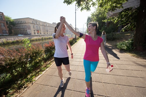 Walkers high fiving after exercising