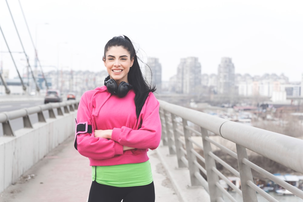 Sporty woman pausing during a walk or run
