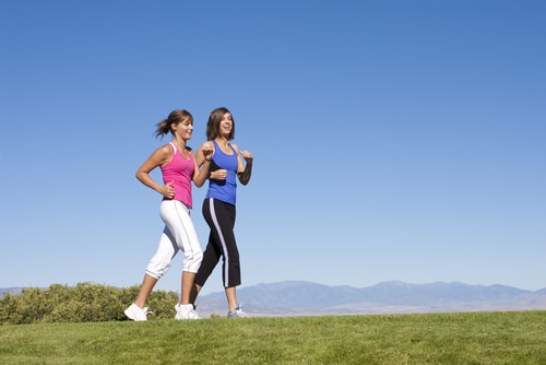 Women power walking for fitness in an open area