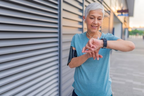 Woman checking fitness watch during walk