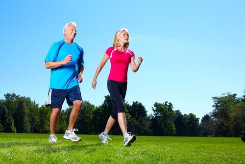 Couple fitness walking on a grassy field