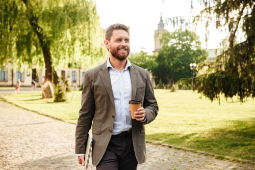 Man walking in the park with coffee