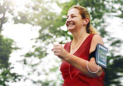 Woman fitness walking listening to headphones