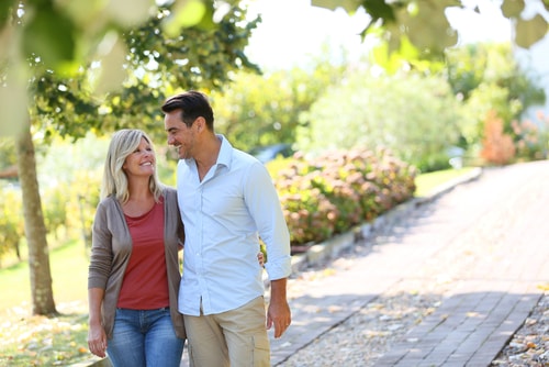 Couple taking a walk in a sunny green park