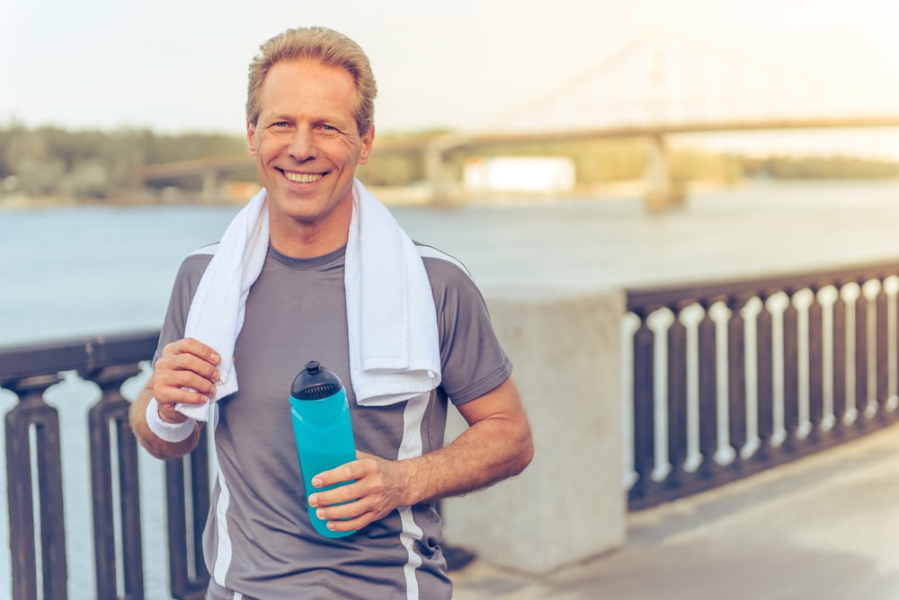 Man taking a break during a walk by the river