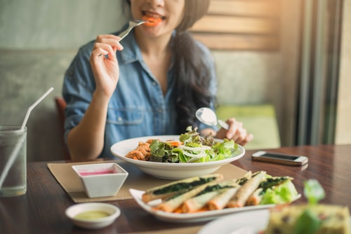 Woman eating a healthy salad and meal