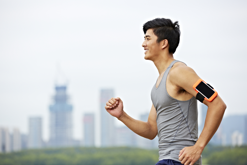 Man walking for fitness with phone armband
