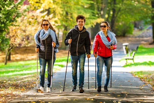 3 people nordic walking on a park path