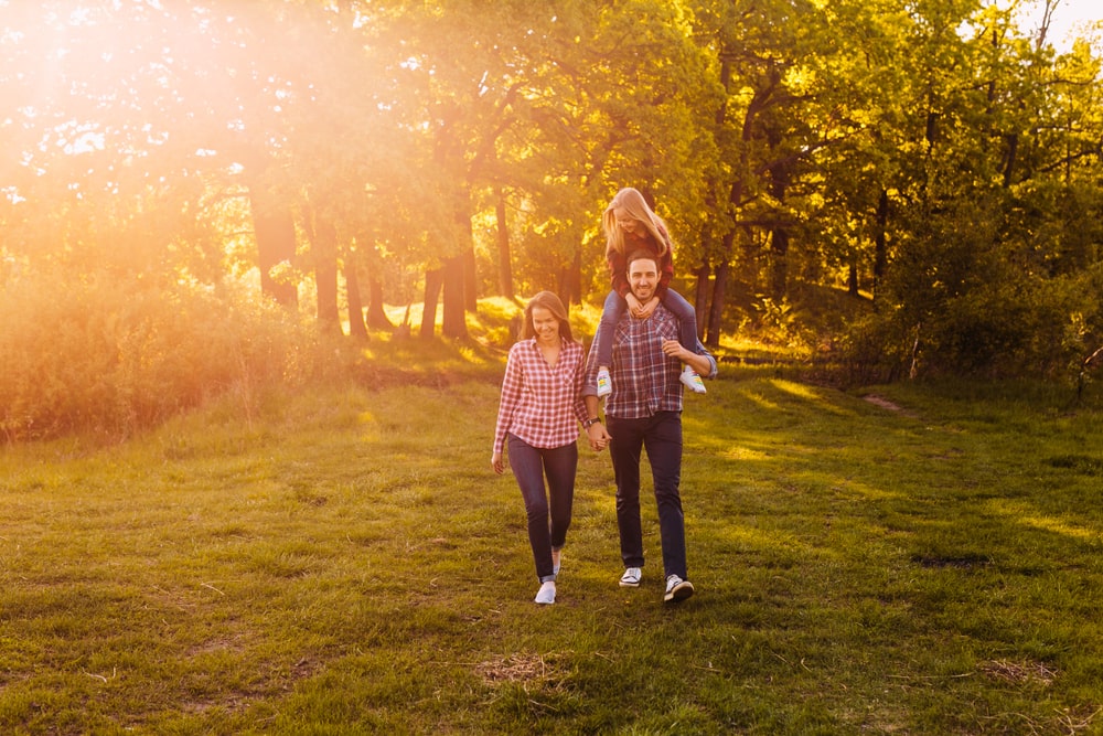 Family walking together in the park after dinner