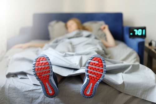 Athlete sleeping in shoes - rest concept