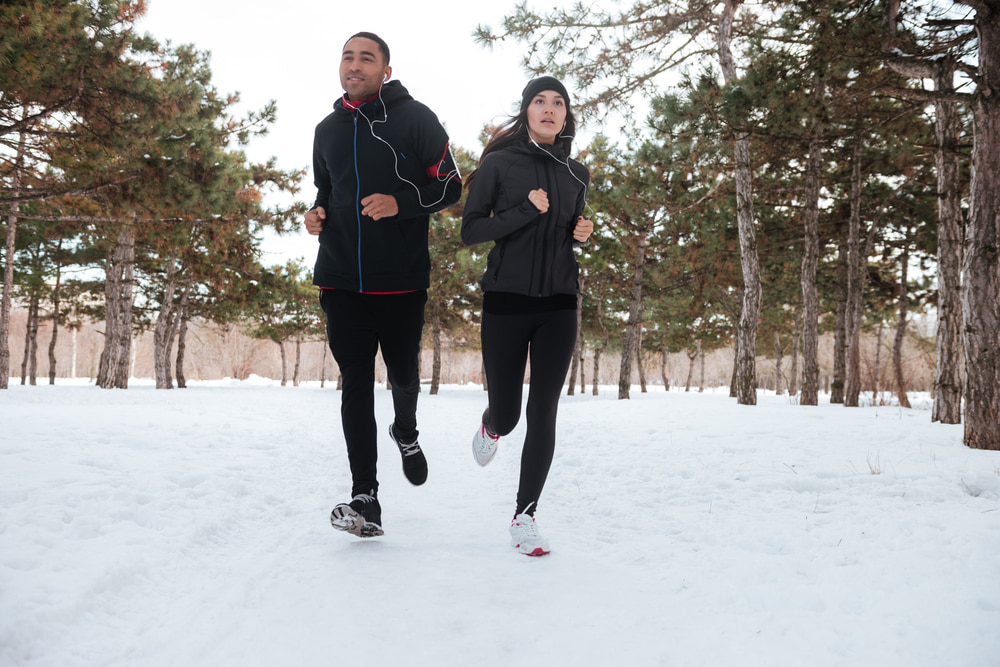 Man and woman walking together in winter snow