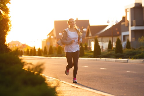 Woman running on deserted street in morning